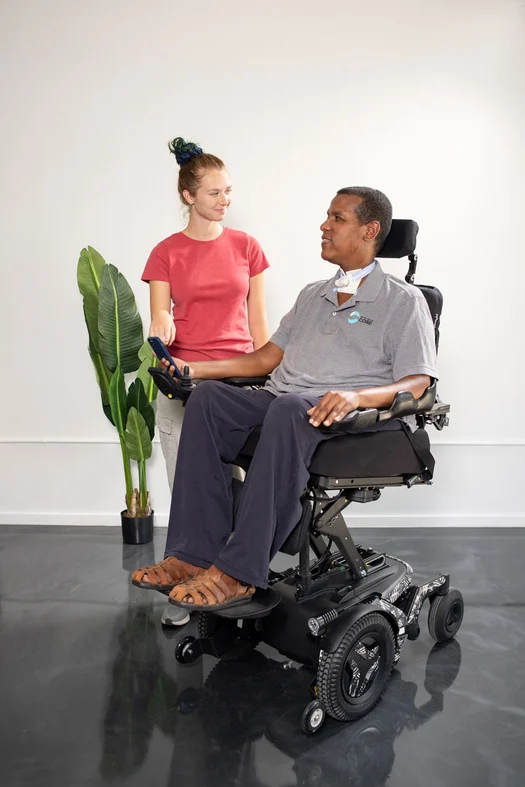 Assistive Technology Professional working with a power wheelchair user during a Complex Rehab mobility assessment.