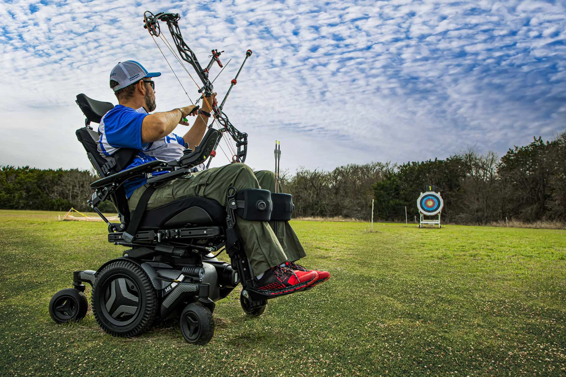 Power wheelchair user participating independently in an outdoor recreational activity.