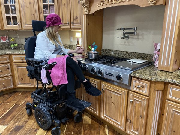 Power wheelchair user participating in everyday activities at home.